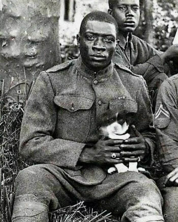 One of the "Harlem Hellfighters" Cuddles a Dog